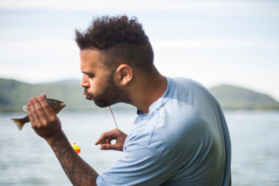 man blowing a fish